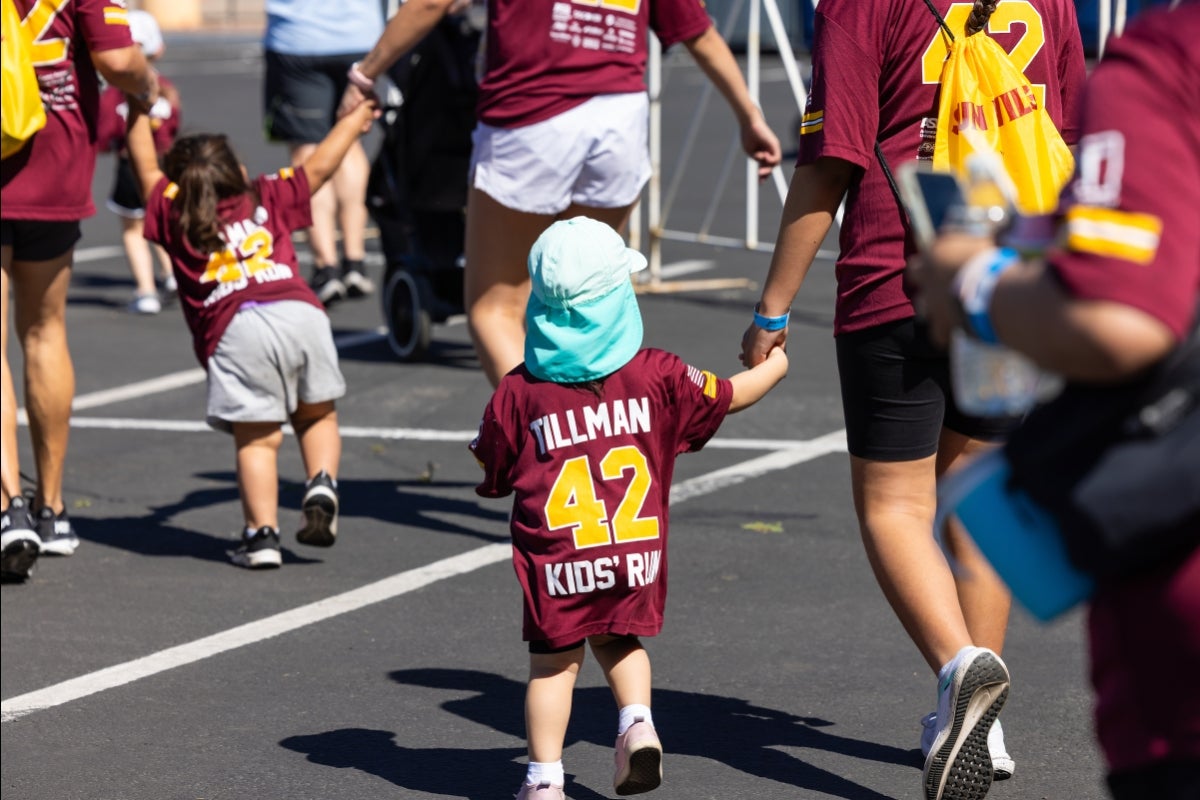 Young kid holding parent's hand