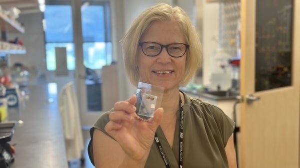 Woman holding small prototype device