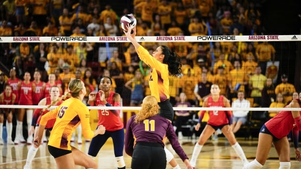 Women playing volleyball.