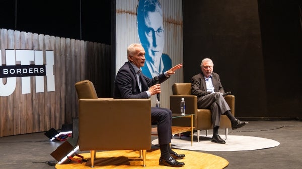 Jorge Ramos and Marty Baron on stage addressing audience