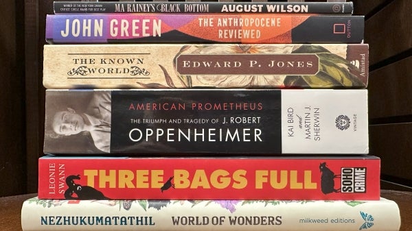 A stack of books sitting on a chair.